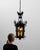 This chandelier makes its impression through dark aged bronze/iron, foliate leaf motif candelabra. It was made in Belgium...