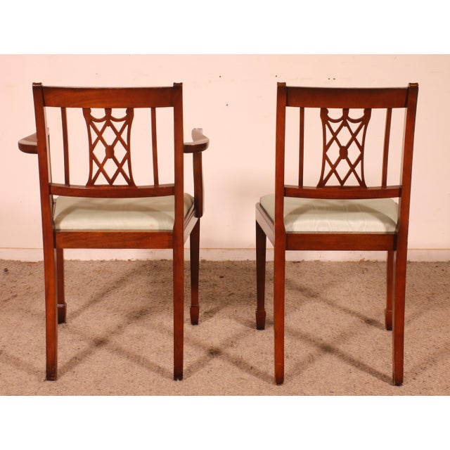 Superb set of 10 chairs and 2 armchairs in the Hepplewhite Revival style, crafted from English mahogany. A beautiful set...