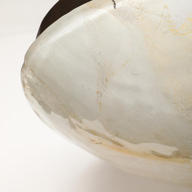 A large Mid-Century Modernist hand-blown Murano glass flush mount chandelier, adorned with gold flecks and bronze...