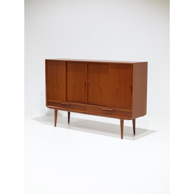 Model 13 highboard, designed by gunni omann for omann jun in denmark, 1960s. This tall sideboard, featuring drawers and...