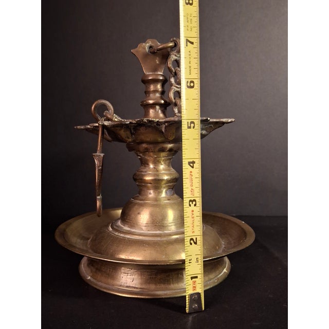Design Significance & Historical Provenance Originating from Central Europe, the star-form seven-wick brass oil lamp...