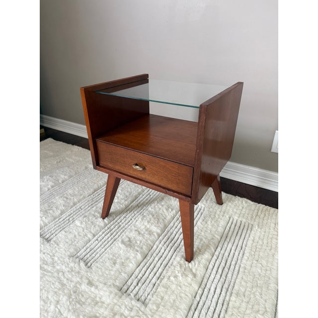 Super cool and hard to find side table made by Mengel for Raymond Loewy. Features a removable glass top, open middle...