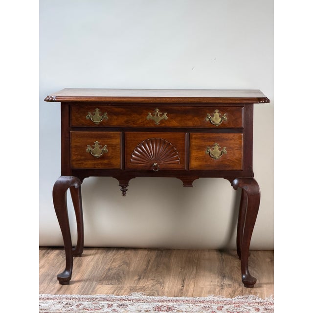 A handsome 18th-century American Queen Anne walnut lowboy dating to circa 1740–1770, with the graceful proportions and...