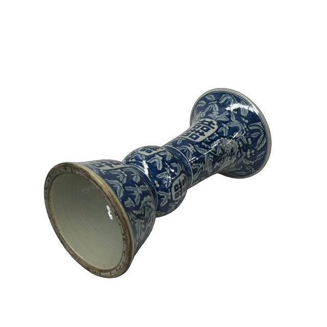 This elegant Chinese blue and white porcelain vase, likely a Gu-shaped vessel or a ritual altar vase, features a striking...