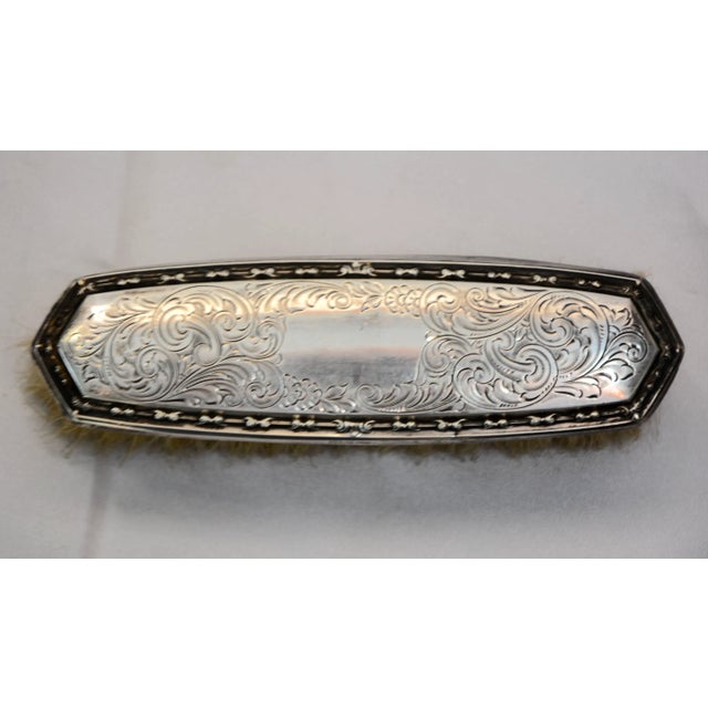 The George K. Webster Company of North Attelboro, Massachusetts, designed this Victorian clothes brush in the late 19th...