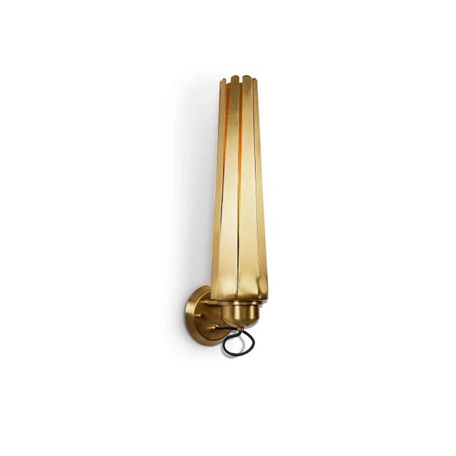 Wall light, a contemporary lighting piece in matte brass. This wall lamp is a versatile piece that will shine like...