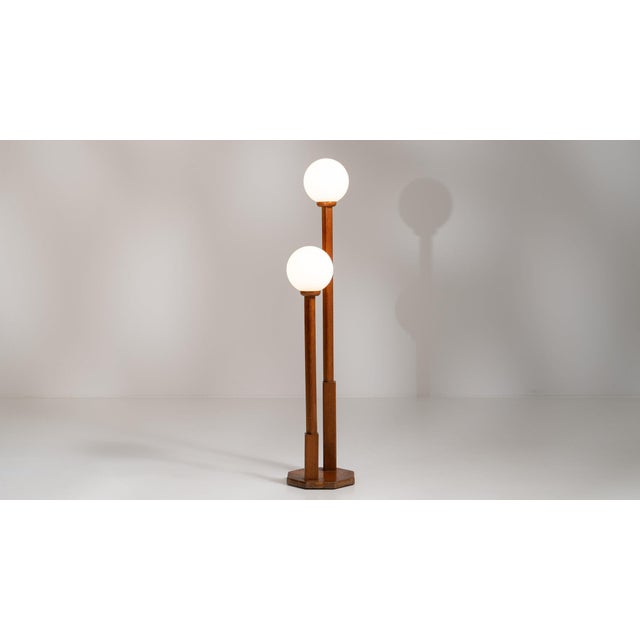 Double-globe floor lamp in Rich Walnut Brown. Finished in rich walnut brown, this double-globe floor lamp is distinguished...
