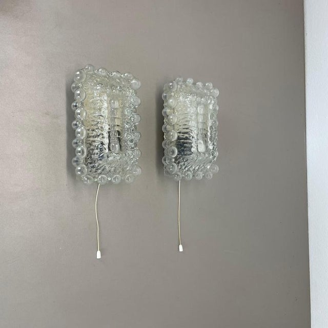 This set of two modernist lights was produced in France in the 1970s. It is made from glass with a abstract patterned...