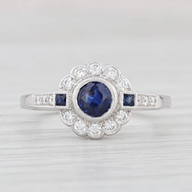 Gemstone Information: - Natural Sapphire - Carats - 0.60ct Cut - Round 0.55ct, Square 0.05ctw Color - Dark Blue Treatment...
