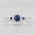 Gemstone Information: - Natural Sapphire - Carats - 0.60ct Cut - Round 0.55ct, Square 0.05ctw Color - Dark Blue Treatment...