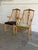 This vintage set of 2 armchairs features an elegant high-back silhouette with subtly curved armrests and contoured back...