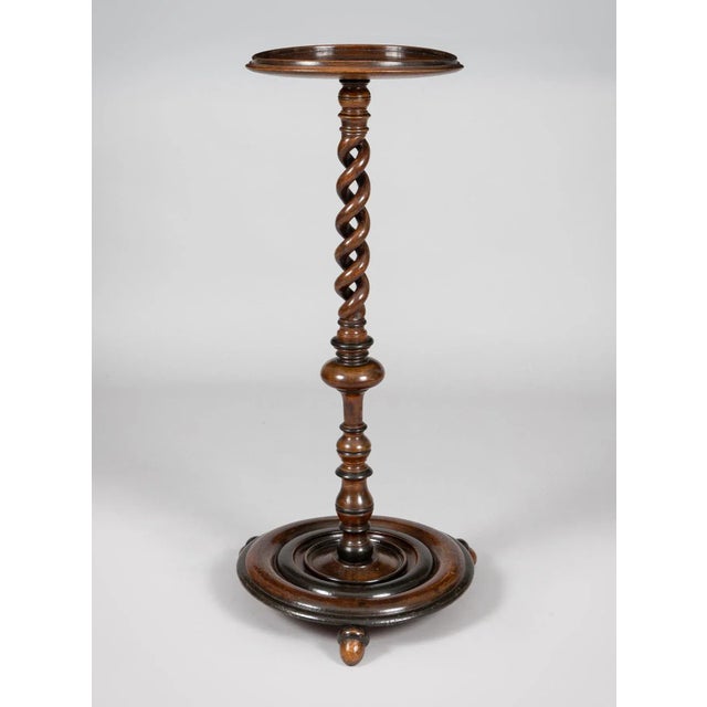 English or French walnut torchere or plant stand, with open barley twist upper section of the pedestal and turned and...