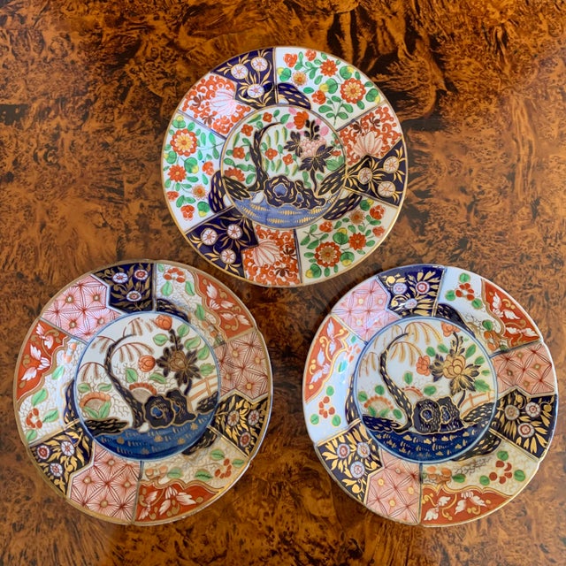 A trio of Coalport plates in the Imari palette comprising two variations on the ca. 1810 pattern: all with the raised foot...
