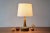 Palshus / Le Klint table lamp with brown haresfur glaze and patinated brass top. This lamp was designed by Esben Klint and...