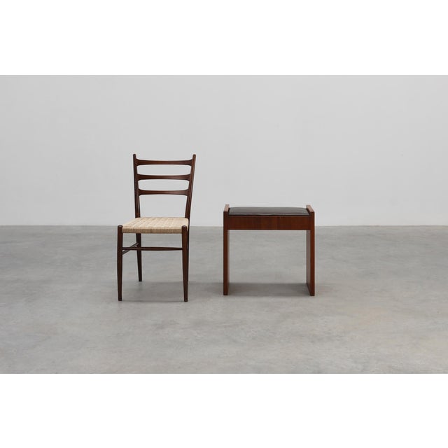 A refined Belgian Art Deco stool from around 1925, crafted in solid walnut with a dark leather seat. The design is...