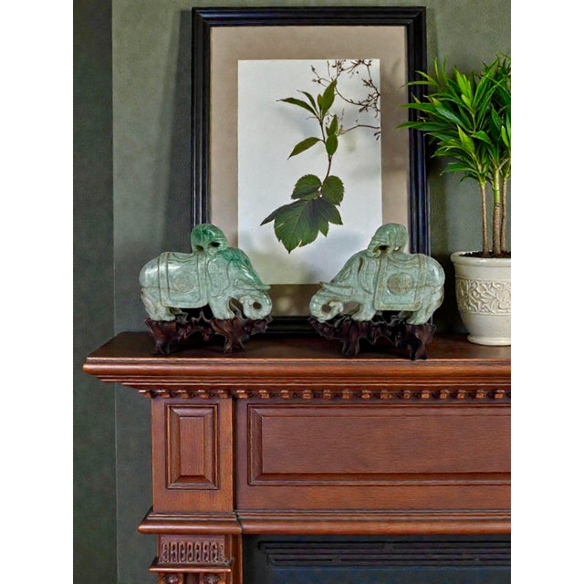 Pair of Chinese Carved Jadeite Elephant Sculptures on Custom Hardwood Stands A finely matched pair of Chinese jadeite...