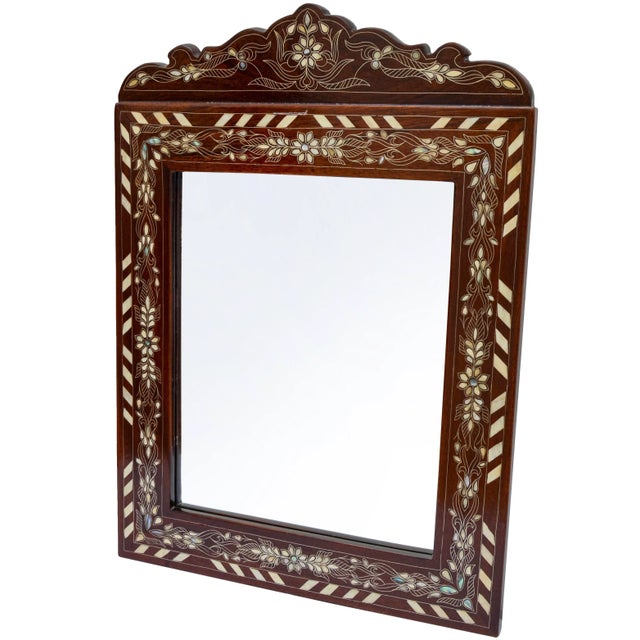 Gorgeous vintage mirror thoughtfully handcrafted exhibiting an ornate hand-carved solid walnut wood with remarkable and...