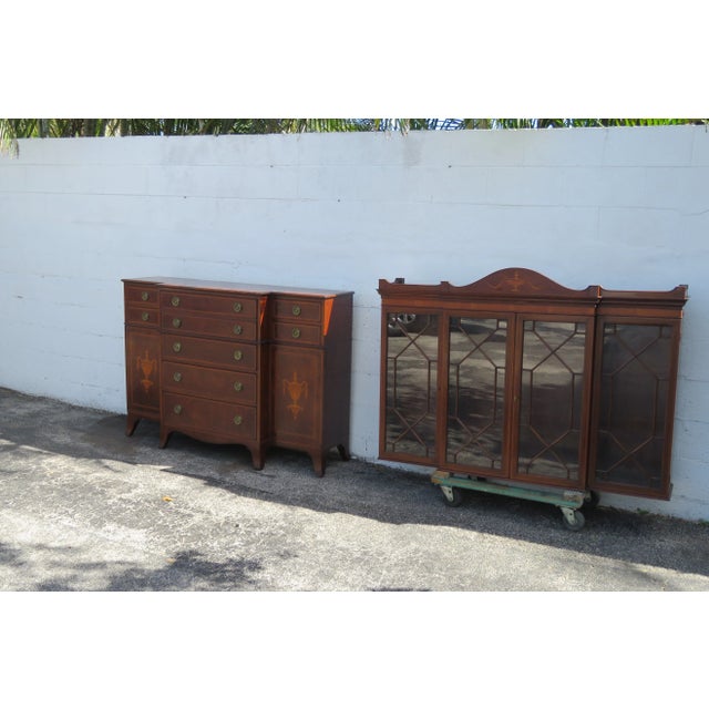This Two Part Breakfront China Cabinet is made of wood, solid wood, mahogany, flame mahogany, veneer, and glass. This...