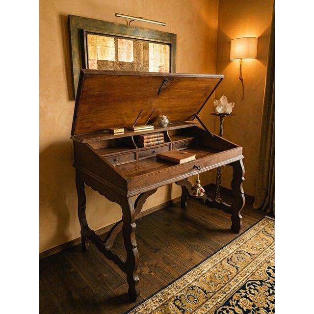 18th-century writing desk with a folding top, refectory-style. An antique Emilian refectory-style writing desk from the...