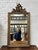 Magnificent antique mirror in plaster and wood. Its glass and wooden frame are original. Its pediment is decorated with a...