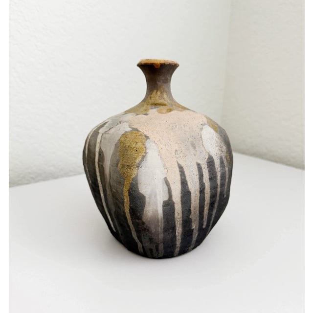 Rustic modern studio pottery vase or weed pot. The vase shape is an irregular square with rounded corners. The clay body...