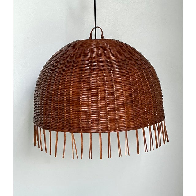 Elevate your interior with this striking monumental rattan dome chandelier, a masterclass in organic texture and mid-...