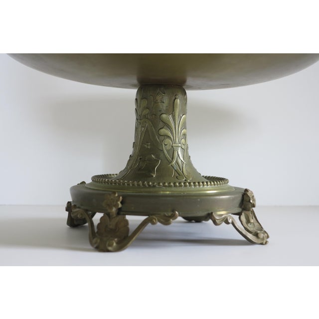 A stunning late Victorian French bronze tazza with a central medallion featuring a neoclassical motif and a base featuring...