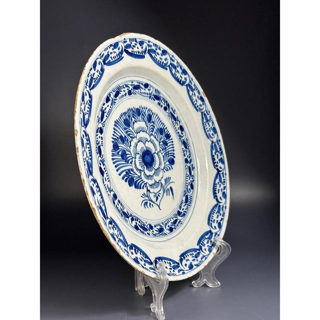 Dutch Delft blue and white 'Peacock' plate, 18th century, the centre decorated in cobalt oxide with containing an...