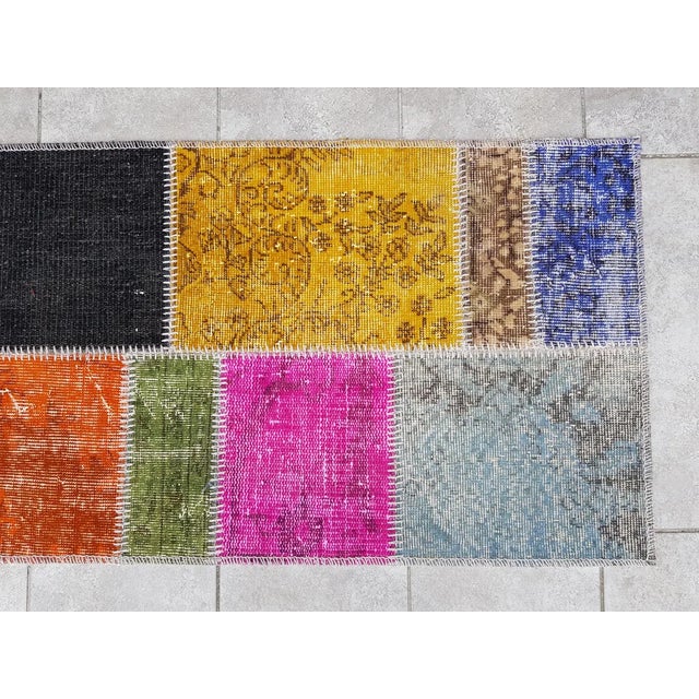 This is a vintage Turkish Oushak rug from the Mid 20th Century. The piece was hand-knotted.