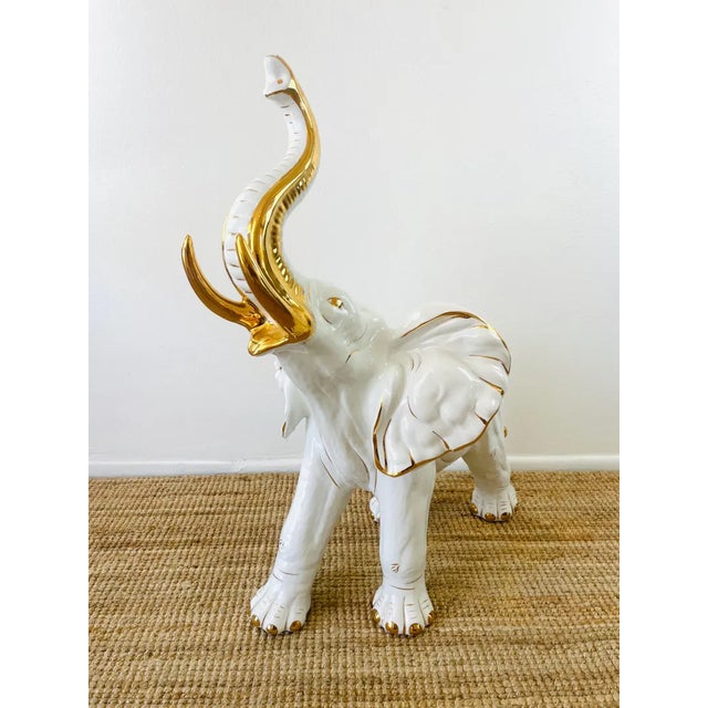 Vintage 1980s White & Gold Ceramic Elephant Statue made of a ceramic type material golds white with gold metallic accents...