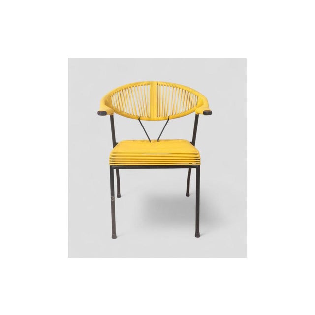 With its bright yellow color and open, enveloping design, this vintage garden chair is a perfect example of 1980s pop...