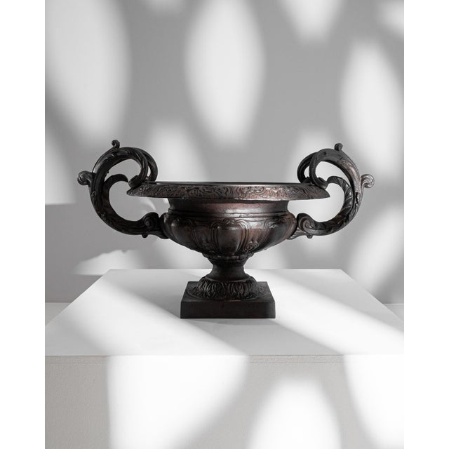 This 19th Century French Cast Iron Planter is a masterpiece of decorative art, infusing aristocratic elegance into any...