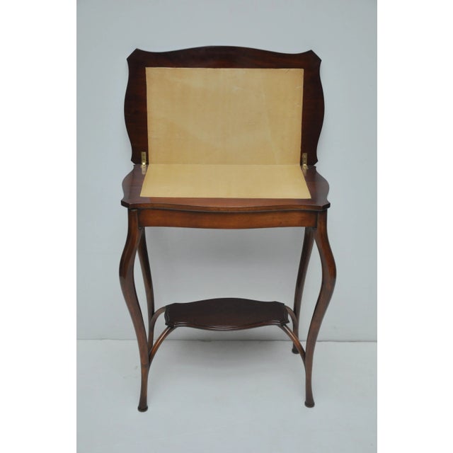 Elegant, small size walnut Queen Anne style swivel game table with cabriole legs and shelf stretcher. Restored with new...