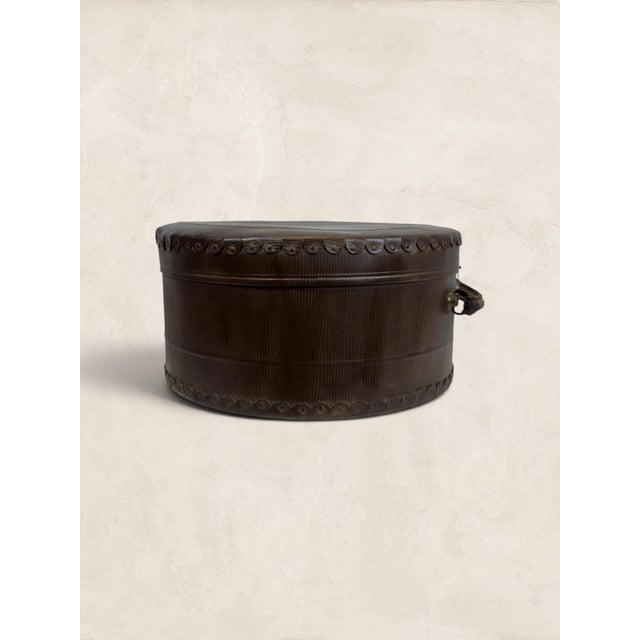 An exceptional English Victorian round hat box dating to circa 1895, crafted in richly textured leatherette with an...