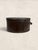 An exceptional English Victorian round hat box dating to circa 1895, crafted in richly textured leatherette with an...