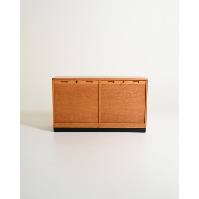 Oak cabinet with two tambour doors and internal shelves. Made by Edsby Verken, Sweden, in 1963. Original manufacturer's...