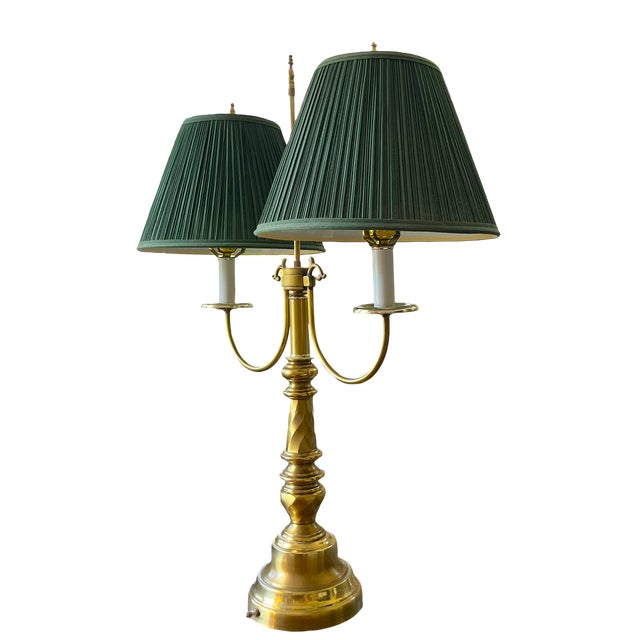 An exceptional vintage brass bouillotte table lamp in the French Empire manner, sourced from a designer’s warehouse where...