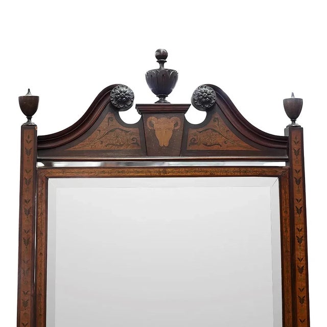An elegant Edwardian cheval mirror crafted in the George III style. The piece features a prominent broken swan-neck...