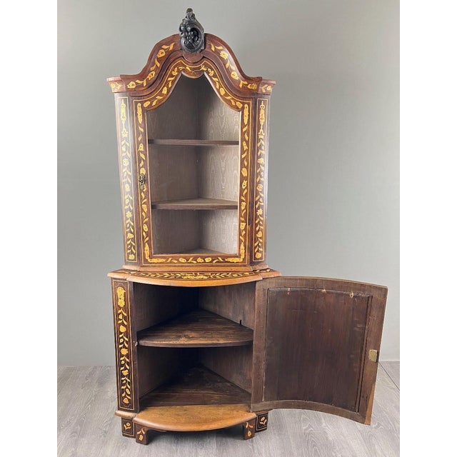 Corner Marquetry Display Cabinet – 19th Century A superb corner marquetry display cabinet in wood, dating from the 19th...