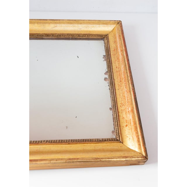 Original fine gold gilding. It is a mid-19th century mirror, circa 1850s. Measurements: 53 x 81 cm (frame), 39 x 67.5 cm...