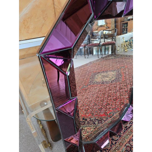 A magnificent and dramatic designer mid century style amethyst glass mirror. Having individually beveled amethyst colored...