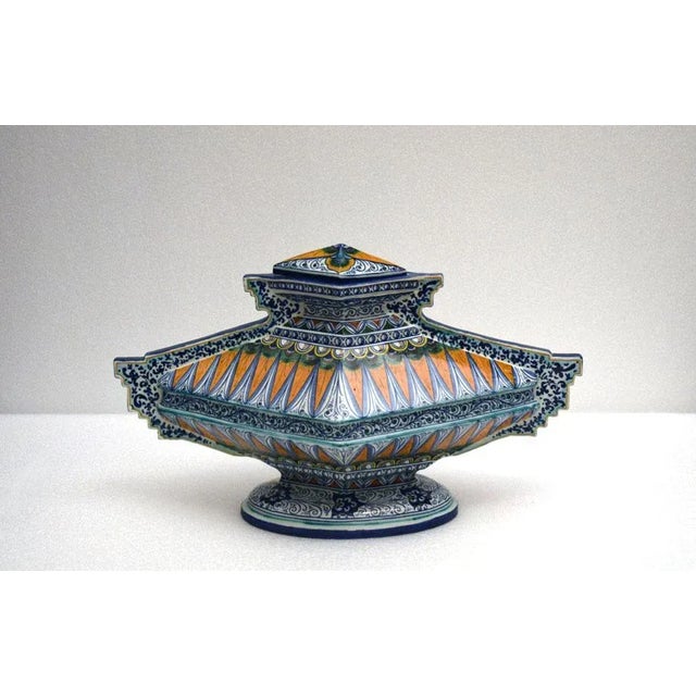 Two large ceramic pots with lid, completely hand decorated in Renaissance style, very particular rhomboid ‘winged’ shape....