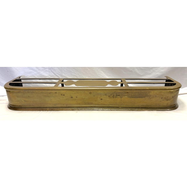Large antique brass fireplace fender from the early to mid 20th century. It is made of heavy brass with an honest patina...