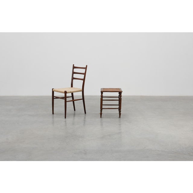A graceful early‑19th‑century French stool, crafted in solid wood with a hand‑woven cane seat. The gently contoured frame...