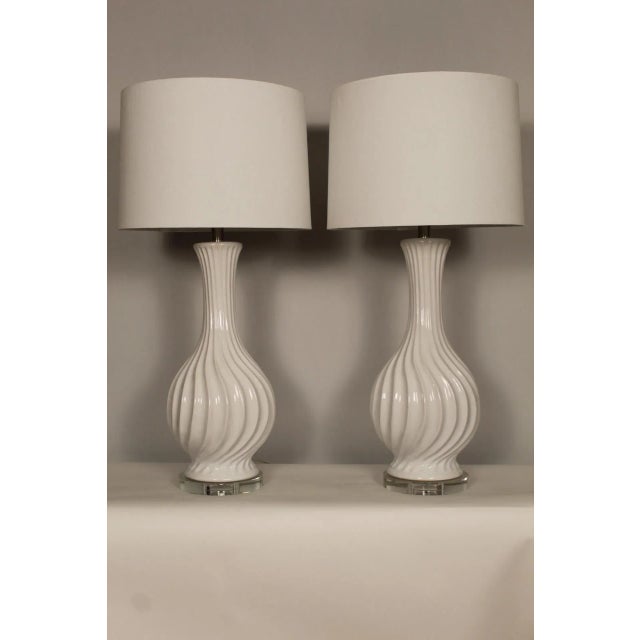 A pair of Dorothy Draper style lamps. Swirled ceramic on crystal mounts. Eggshell in color. Sculptural in presence. Draper...