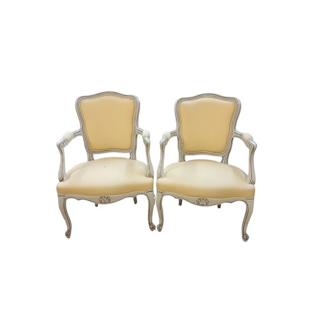 Elegant pair of Louis XV style accent chairs (mid/late 20th century). The molded and carved wooden frame, adorned with...