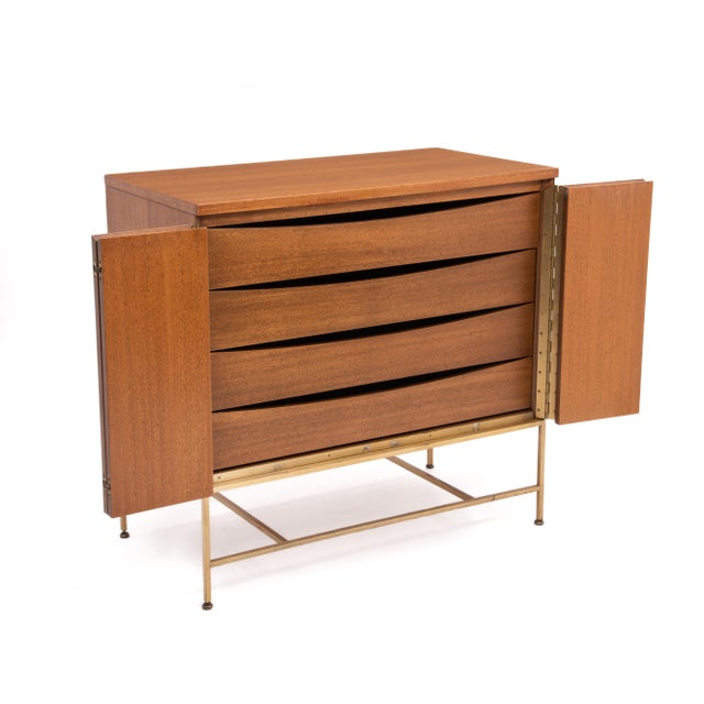 A Calvin "Irwin Collection" mahogany and brass cabinet designed by Paul McCobb. Designed to be a dresser, this versatile...