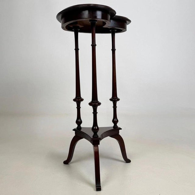 A rare and highly decorative 20th-century side table, beautifully crafted in mahogany and distinguished by its unusual...