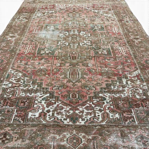 This vintage Heriz rug, approximately 80 years old, showcases the distinctive geometric character of traditional Heriz...