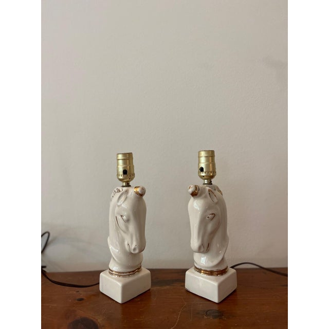 Pair of ceramic lamps of chess piece-horse-heads, or unicorns for a child's bedroom.